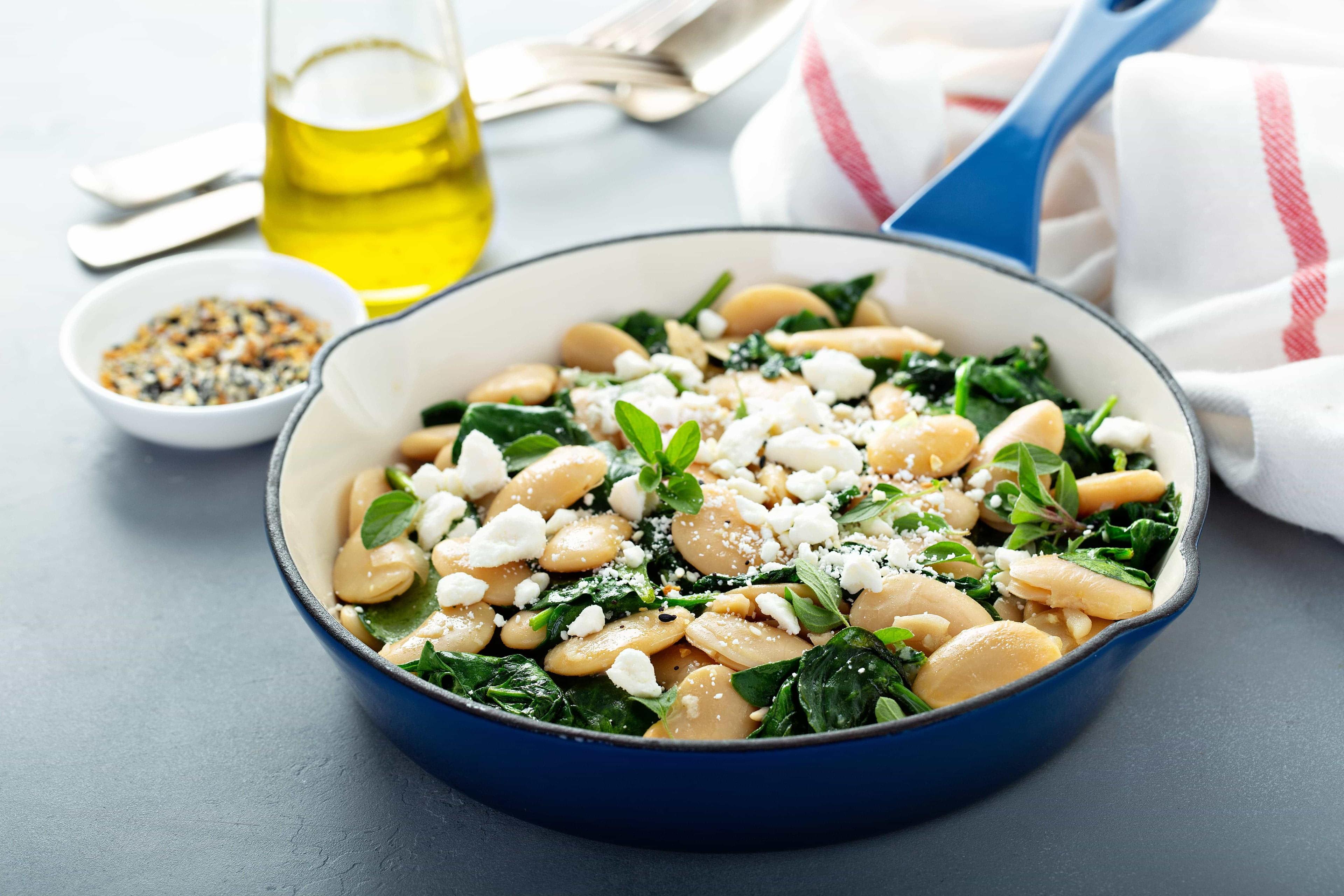 Escarole and beans with grated mozzarella and a rosemary sprig.